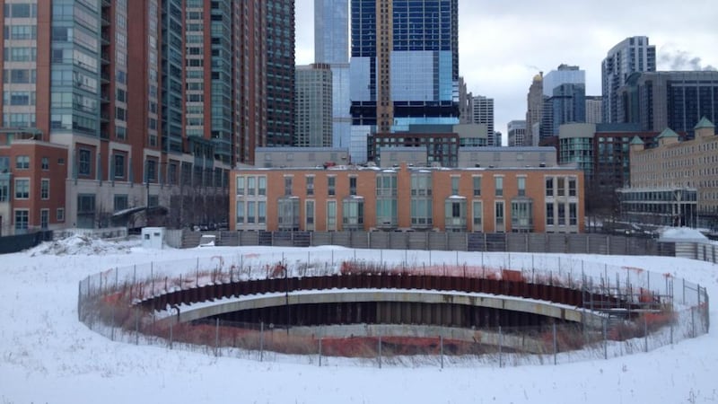 Then and now: a hole in ground where spire is supposed to be