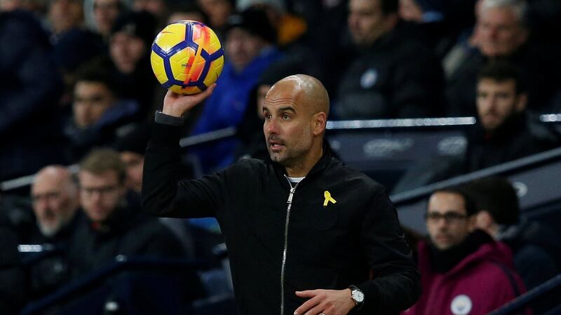 Pep Guardiola again wore a yellow ribbon in support of Catalan politicians who have been jailed for pushing for independence from Spain. Photograph: Reuters