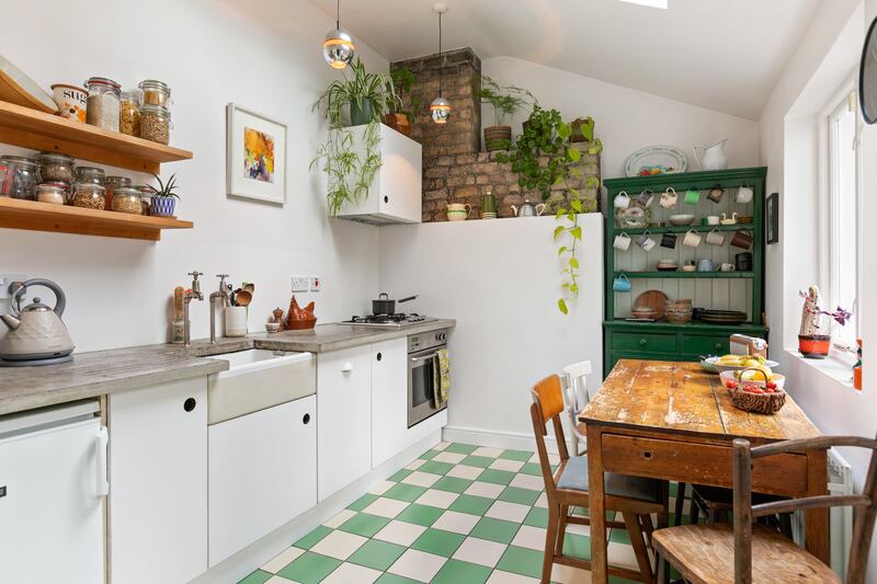 The simple kitchen has poured concrete countertops and opens out to the rear garden.