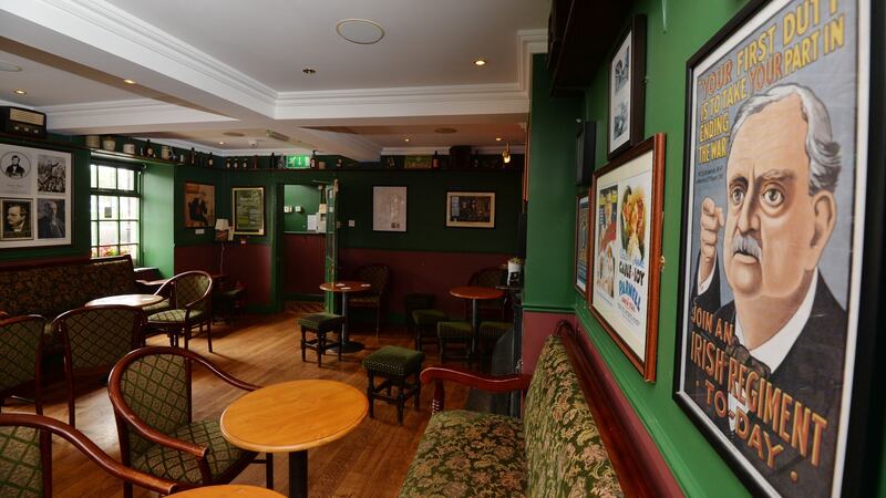 The front bar of the Home Rule Club in Kilkenny, which is adorned with old political campaign material of the early 1900s. Today, the club is not political at all, according to one of its members. Photograph:  Alan Betson