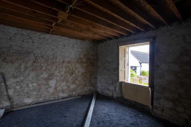 The windows were removed and brought to be refurbished while the plasterer started chipping the old plaster off the mud and stone walls. Photograph: Patrick Browne
