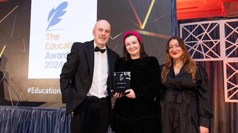 Eoin McCarthy, awards judge, presents the best language school award to Emily Hillyer and Nur Aydin, Irish College of English