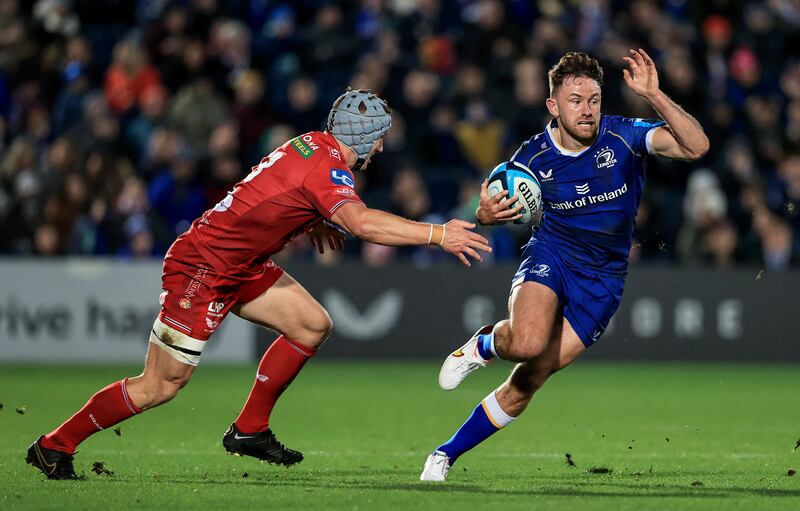Hugo Keenan of Leinster tries to evade the tackle of Scarlets' Jonathan Davies. Photograph: Dan Sheridan/Inpho 