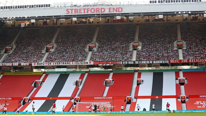 Anthony Martial scores his second goal in front of empty Stretford End at Old Trafford during the Premier League game against Sheffield United. Photograph:   Michael Steele/Pool/AFP via Getty Images