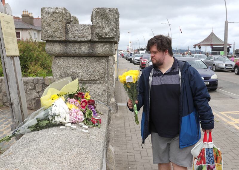 Daniel McDyer leaving flowers outside Sinéad O'Connor’s former house in Bray. Photograph: Colin Keegan/Collins