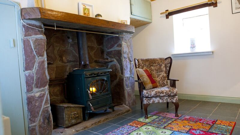 The Coole West property boasts a half-door and a pink sandstone-lined fireplace.