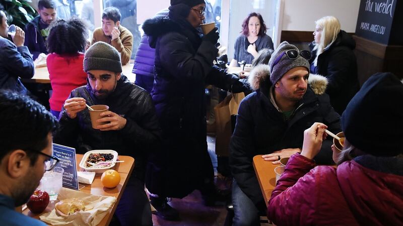 People eat a free lunch at a pop-up eatery hosted by celebrity chef José Andrés for furloughed government employees and their families, in Washington, DC. Photograph: by Mark Wilson/Getty Images