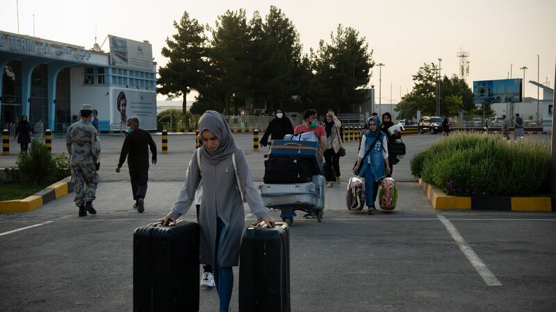 People pass through checkpoints at the Hamid Karzai International Airport in Kabul ahead of the Taliban’s arrival, where one resident described seeing women crying by the side of the road, desperately trying to get a ride home and to barricade their doors. Photograph: Jim Huylebroek/The New York Times