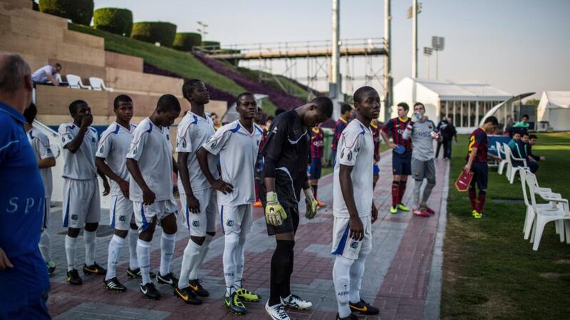 Students with Aspire Football Dreams, in white, line up before a match with FC Barcelona’s youth team, in Doha, Qatar, on January 27th, 2014. Phtograph: Bryan Denton/The New York Times