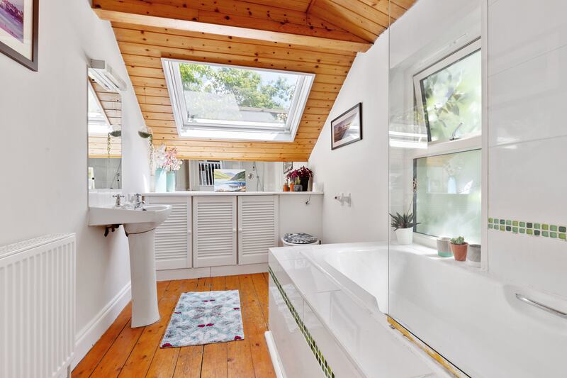 The bathroom is located above the kitchen at the rear of the house.