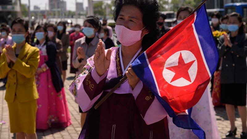 A woman wearing traditional dress and holding a North Korean flag watches a performance celebrating the 89th anniversary of the founding of the Korean People’s Revolutionary Army,  in Pyongyang on April 25th, 2021. Photograph:   Kim Won-jin/AFP via Getty Images