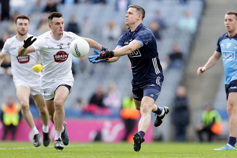 
Dublin goalkeeper Stephen Cluxton gets his pass away despite the attentions of Kildare's Eoin Doyle at Croke Park. Photograph: Laszlo Geczo/Inpho