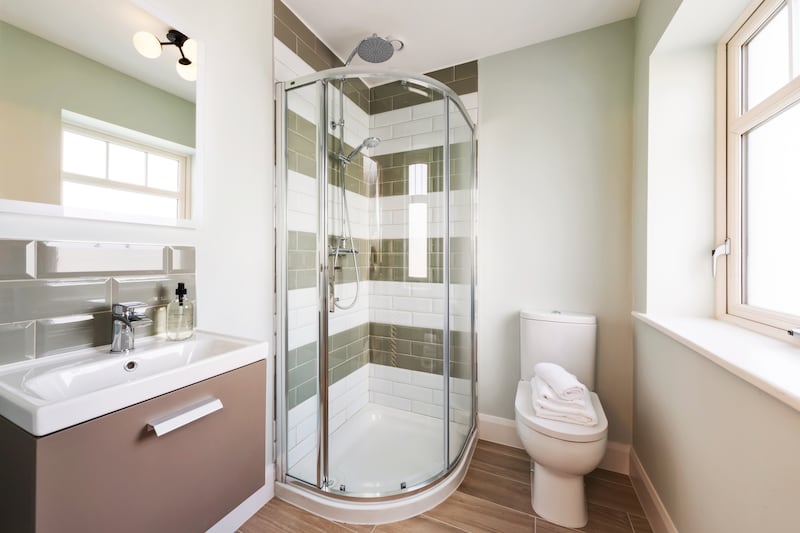 There is dual-colour subway-style tiling in the bathrooms and en suites.