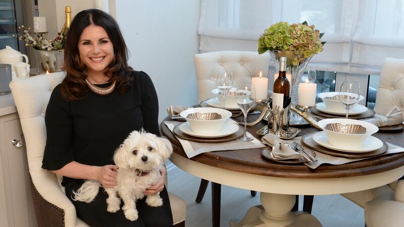 Lisa Cannon sets her table with charger plates, simple flowers and lots of candles