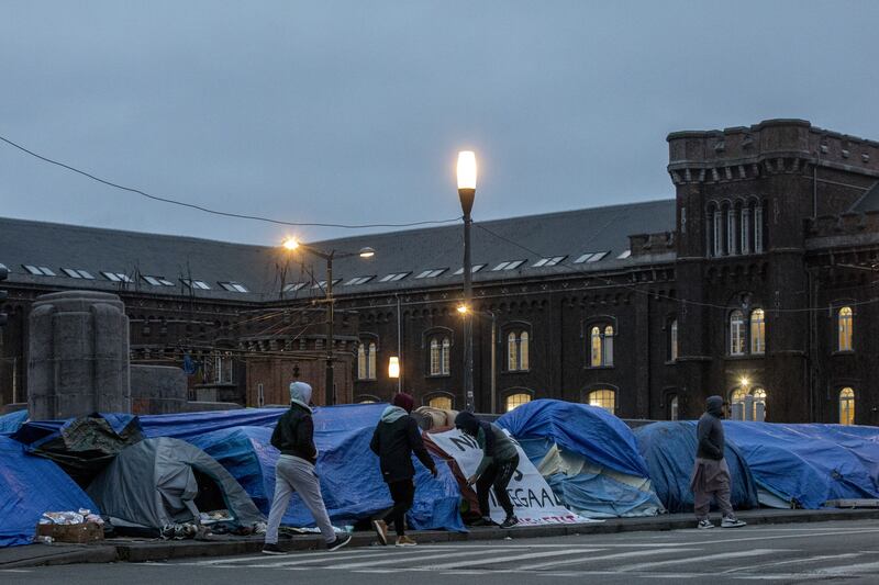 Refugees walk near tents in front of the Petit Chateau - Klein Kasteeltje Fedasil Arrival centre in Brussels in February of this year. Photograph: Hatim Kaghat/ Belga/ AFP via Getty Images