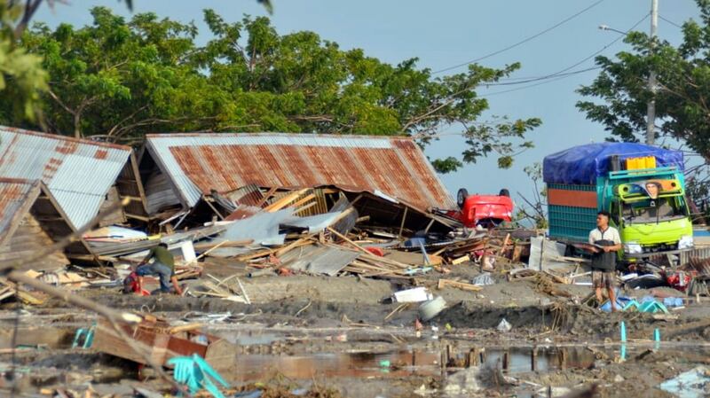 A man stands amid the damage caused by a tsunami in Palu,  Indonesia. Photograph: AP