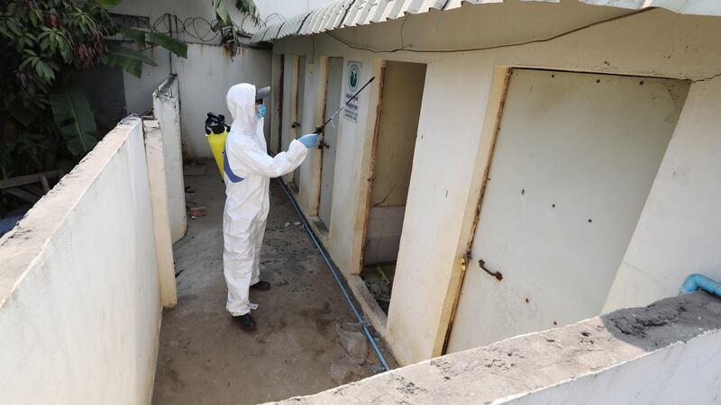 A member of the Cambodian Children’s Fund sprays disinfectants, as a precautionary measure against the spread of coronavirus. Photograph: Mak Remissa/EPA