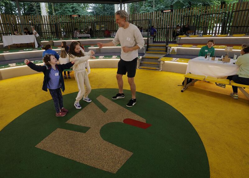 Saoirse, Leah and Steven Griffin get up for a dance in the amphitheatre. Photograph: Alan Betson/ The Irish Times