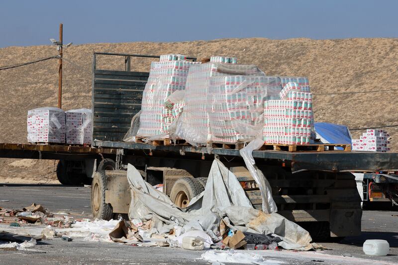 Damaged humanitarian aid for Palestinians in Gaza lies scattered on the ground next to broken-down trucks near the border with the Gaza Strip, close to the Kissufim crossing in southern Israel. Photograph: Jack Guez/AFP via Getty Images