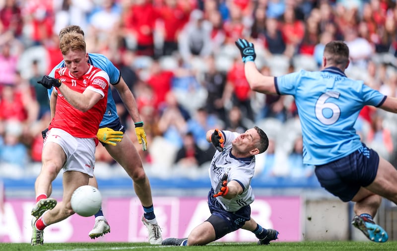 Louth's Ciaran Keenan shoots past Dublin goalkeeper Stephen Cluxton to score his side’s first goal of the game. Photograph: Tom Maher/Inpho