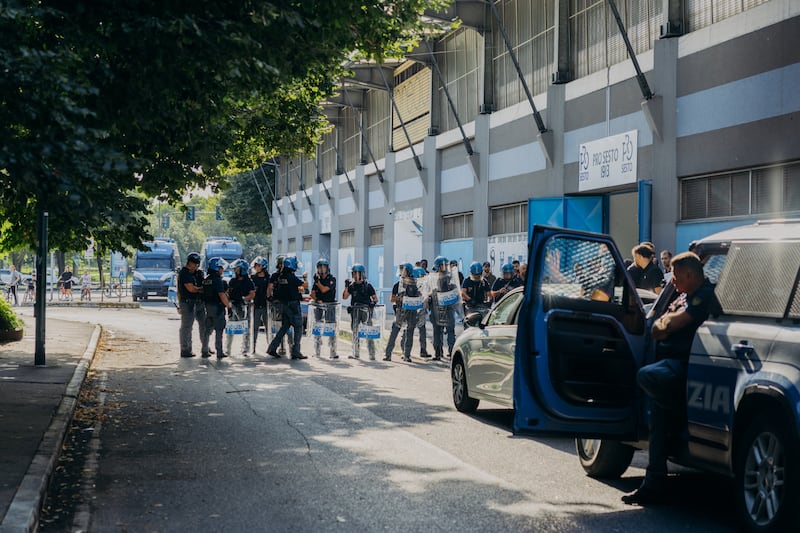 Police in riot gear stand outside Ernesto Breda Stadium for a match between Libyan teams Al Ahly Tripoli and Al Ittihad. Photograph: Camilla Ferrari/The New York Times
                      