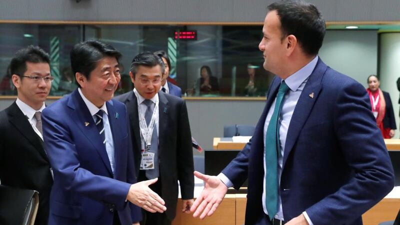 Taoiseach Leo Varadkar greets Japan’s prime minister Shinzo Abe at the EU summit in Brussels on Thursday. Photograph:  Yves Herman/Reuters