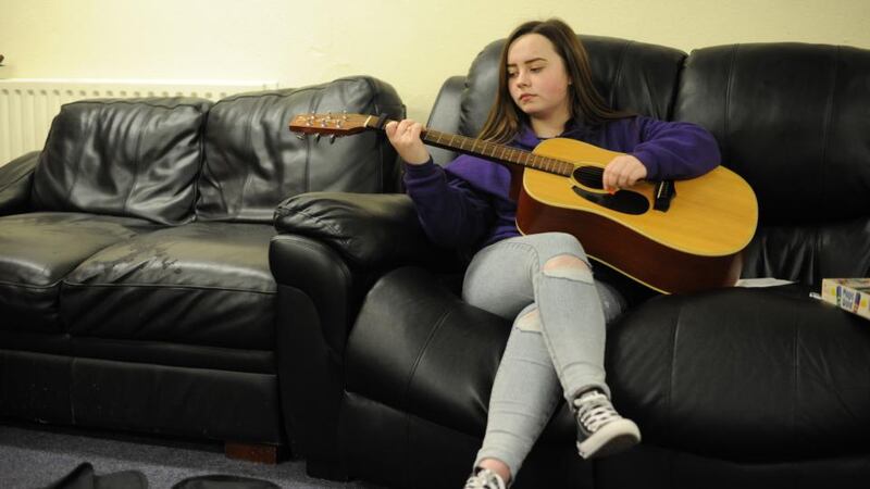 Megan Kavanagh (16) playing guitar in the Swan youth services music group in the Swan Centre in Ballybough, Dublin. Photograph: Aidan Crawley