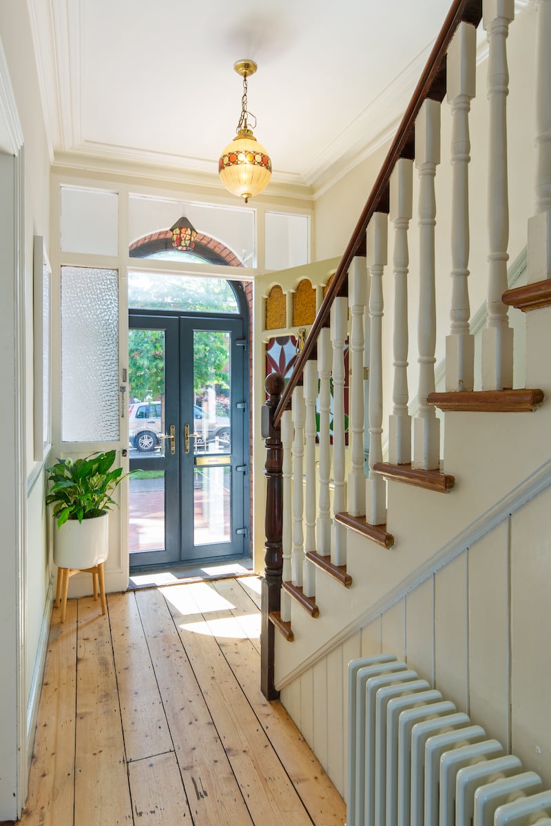 The porch has a blue-framed glazed door showcasing colourful stained-glass. Photograph: Keith Owens