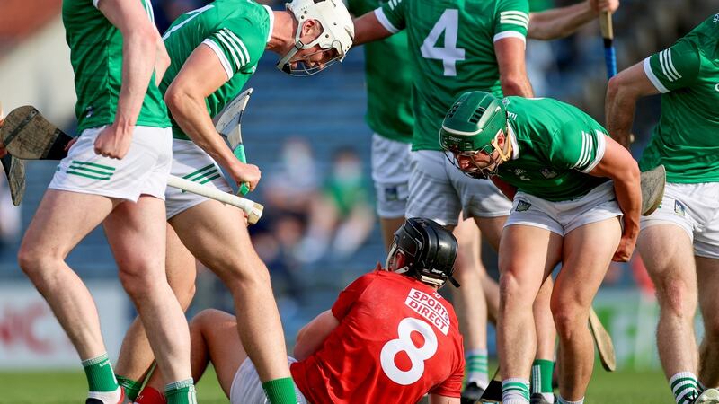 Limerick’s Kyle Hayes and Sean Finn celebrate winning a free against Darragh Fitzgibbon of Cork. Photo: James Crombie/Inpho