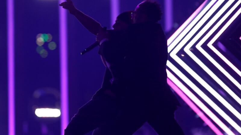 Security subdues a person who invaded the stage as the United Kingdom’s SuRie was performing in Lisbon. Photograph:  Pedro Nunes/Reuters
