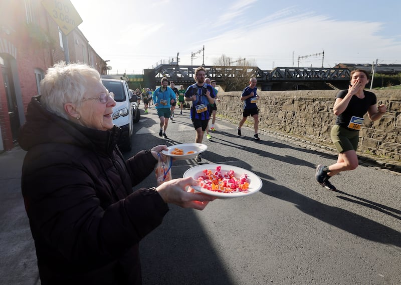 Marie Gorman offers the racers sustinance in the closing stretches of the race.  Photograph: Alan Betson/The Irish Times
