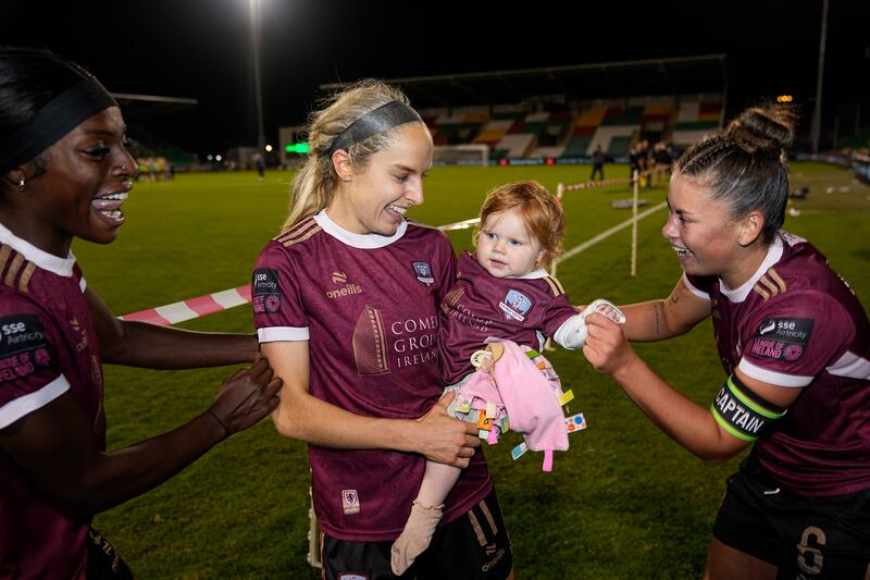 Julie-Ann Russell with her daughter Rosie and Galway United teammates Jenna Slattery and Rola Olusola after victory against Shamrock Rovers in the 2024 All-Island Cup final at Tallaght Stadium. Photograph: James Lawlor/Inpho