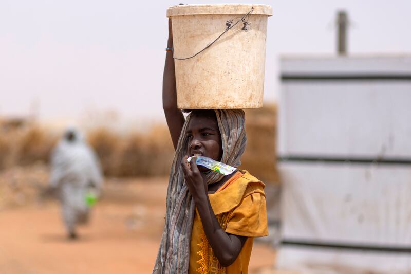 A girl carries food in the camp. Photograph: Chris Maddaloni
