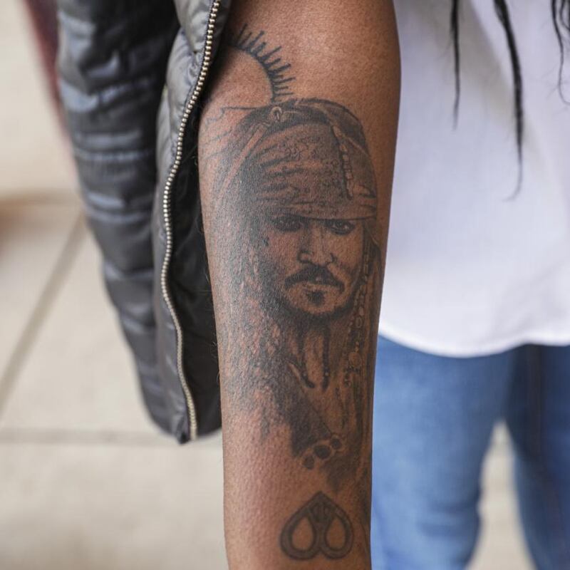 Johnny Depp fan Teresa Lima shows a tattoo of the actor on her arm. She travelled from Portugal to attend the trial. Photograph: Valerie Plesch/The New York Times