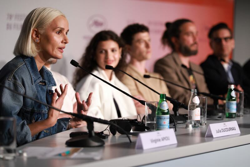 Julia Ducournau speaks on stage during a press conference promoting Alpha at the Cannes Film Festival. Photograph:  Clemens Bilan/Pool/Getty 