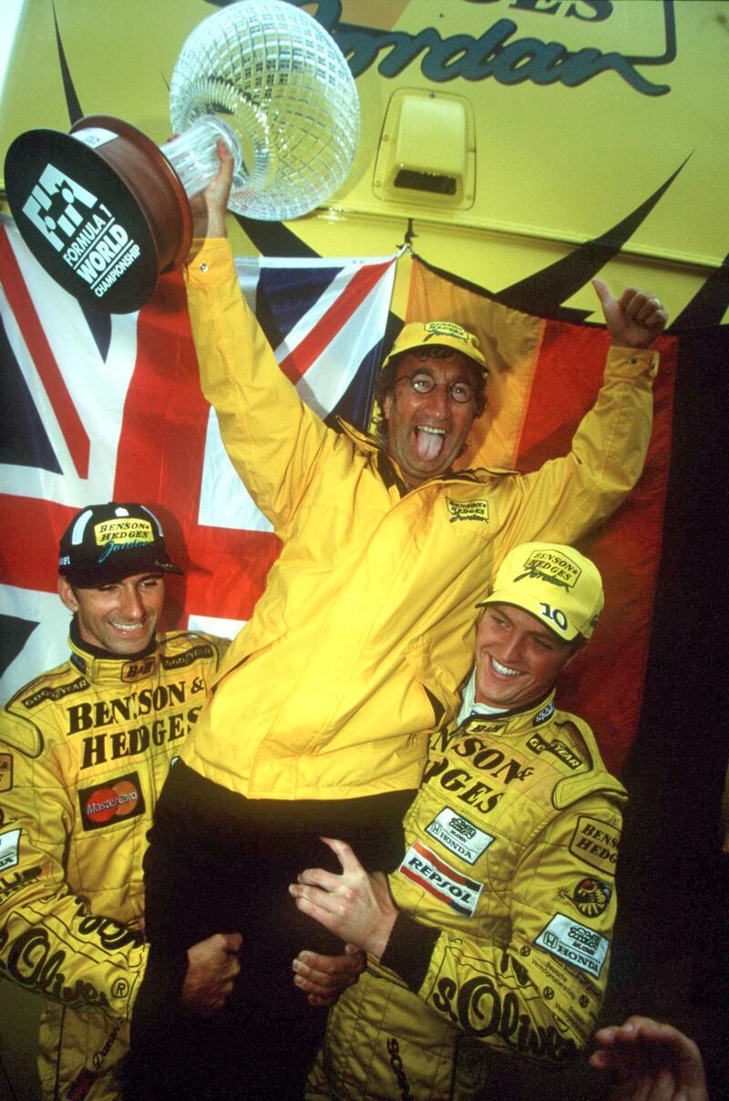 Eddie Jordan is held aloft by Jordan drivers Damon Hill (left) and Ralf Schumacher after their one-two finish in the 1998 Belgian GP. Photograph: Inpho/Allsport