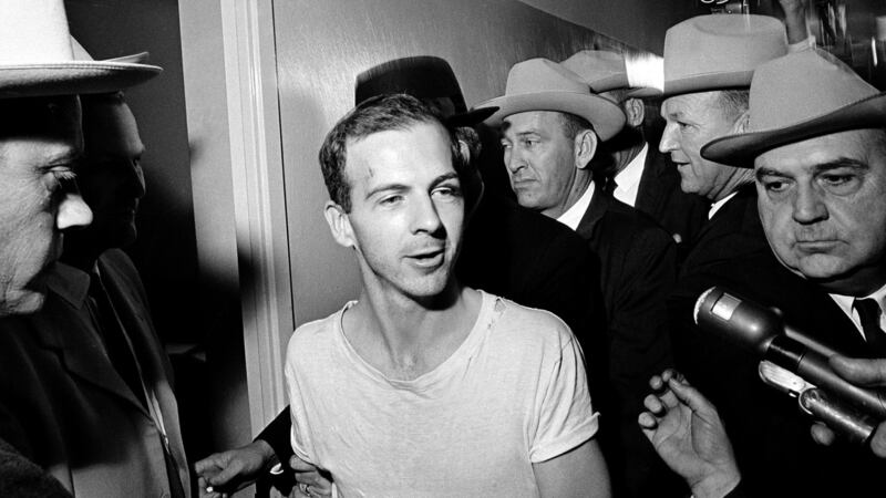 Lee Harvey Oswald talks to the media as he is led down a corridor of the Dallas police station on November 23rd, 1963  for  questioning in connection with the assassination of John F Kennedy. Photograph: AP