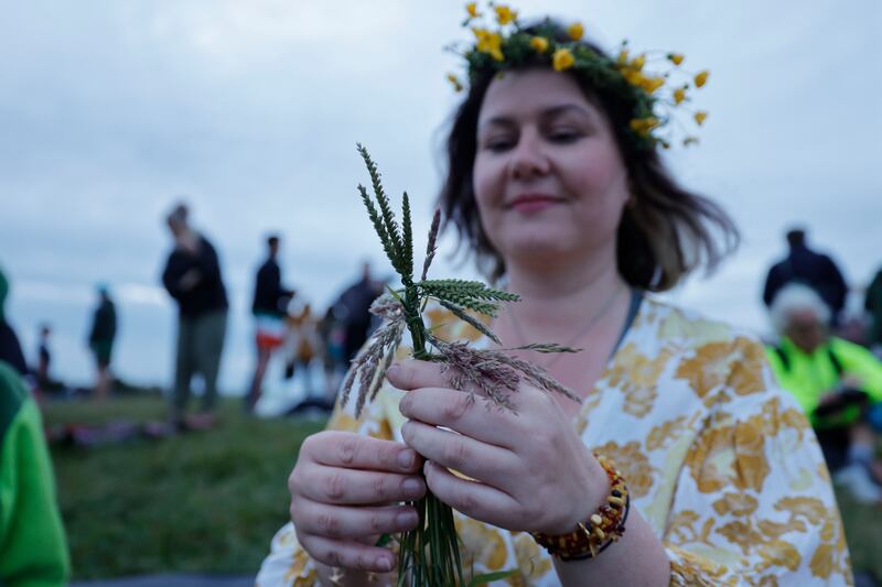 Inga Herman practising a Lithuanian tradition of making wishes and creating floral headbands. Photograph: Alan Betson