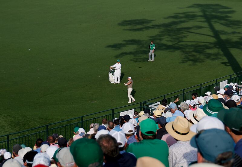 Rory McIlroy plays a shot into the 15th green - and the water - on his way to a double bogey. Photograph:  Harry How/Getty Images