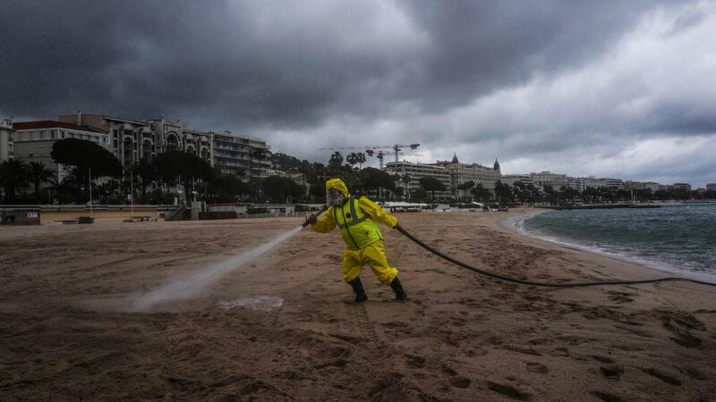 A technician sprays disinfectant on the beach of the French Riviera city of Cannes on May 29th as France progressively eases lockdown measures taken to curb the spread of  Covid-19.  Parks, gardens, beaches and lakes in France will re-open on June 2nd. Photograph: Valery Hache/AFP via Getty