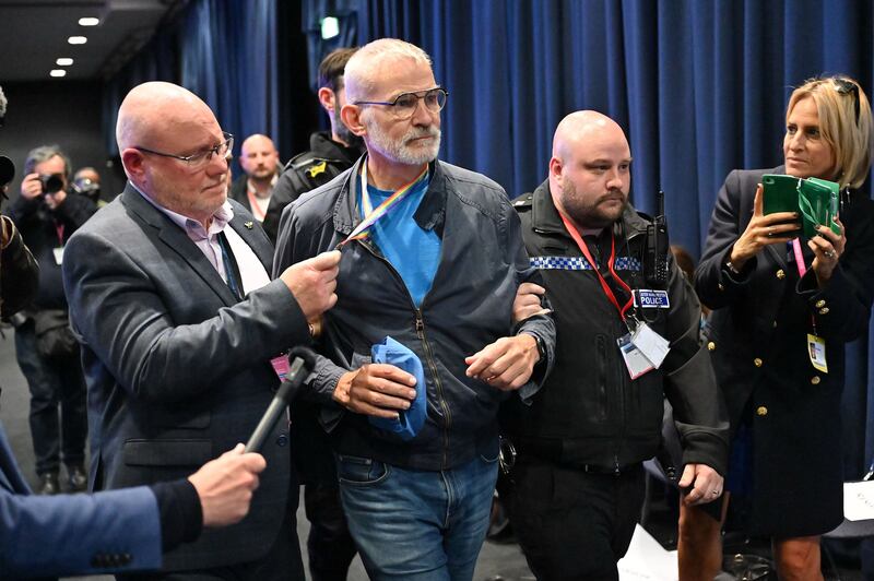 Andrew Boff is escorted from the hall by security criticising the conference speech of Britain's home secretary Suella Braverman. Photograph: Justin Tallis/Getty