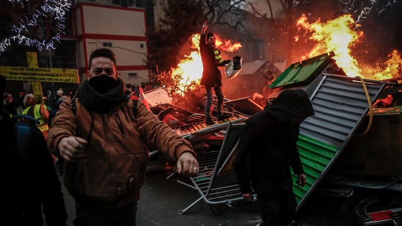 Protesters build a barricade  as clashes with  French riot police erupt during a ‘yellow vests’ protest in Paris, France. Photograph: Ian Langsdon/EPA