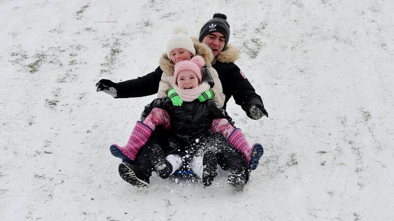 John, Ruby and Gracie Mae Reilly from Palmerstown sledging and sliding at the papal cross in the Phoenix Park during the snowfall associated with Storm Emma. Photograph: Alan Betson