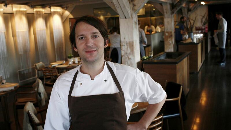 Chef Rene Redzepi is seen through a window as he poses in his Noma restaurant in Copenhagen. Photograph: Christian Charisius/ Reuters