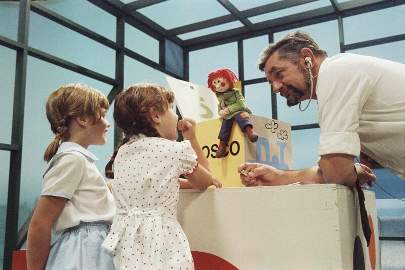 1983: Floor manager Walter Harrington introduces two girls to Bosco. Photograph: John Coone/RTÉ