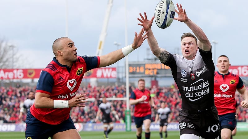 Munster’s Simon Zebo bats the ball away from  Chris Ashton in the opening seconds. Photograph: Gary Carr/Inpho