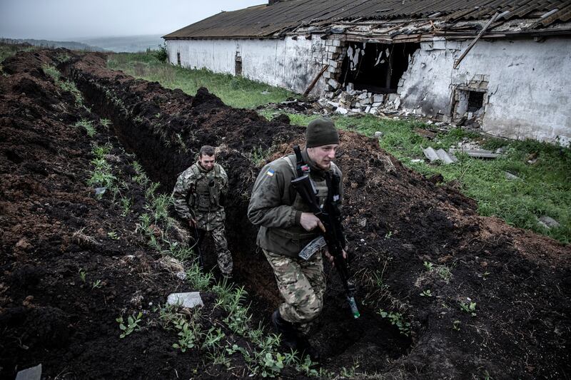 Ukrainian soldiers from the 95th Air Assault Brigade return from sentry duty in a trench system along the front line near Izyum, Ukraine on May 27th. 