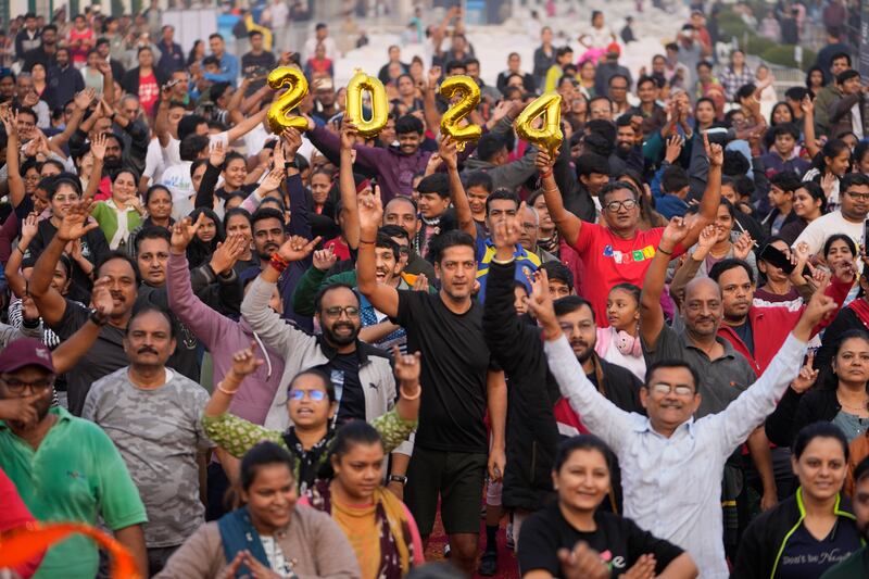 People celebrating during an event to say goodbye to 2023 and welcome the new year in Ahmedabad, India. Photograph: Ajit Solanki/AP