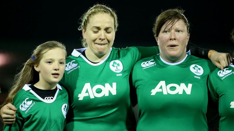 Ireland’s Niamh Briggs and Ruth O’Reilly with the team’s mascot during the national anthem prior to a Six Nations game against France. Photograph: Dan Sheridan/Inpho