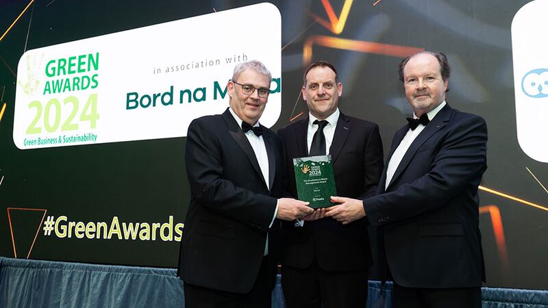 Paul O'Brien, group corporate account manager at Panda, presents the excellence in waste management award to Donal Gibson and Denis Connolly, Wisetek